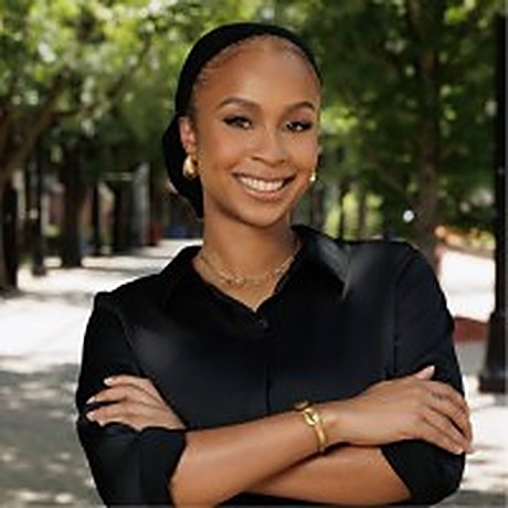 Tia James, brand identity director and creative, smiling with arms crossed